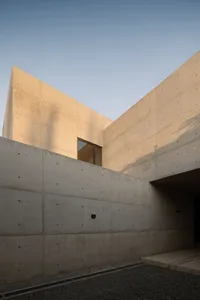 Modern residential exterior featuring a minimalist design in concrete