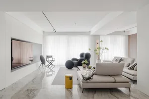 Modern living room featuring a marble floor and white walls with a large window and minimalistic furniture.