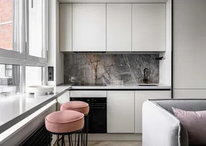 Modern minimalist kitchen with white laminate cabinetry and marble countertops