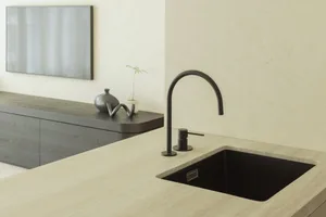 Modern kitchen with a black marble countertop and sink