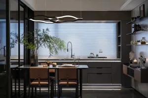 Modern kitchen with metallic finishes and minimalist design elements.