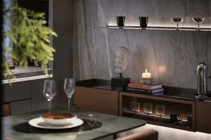 A modern living room with wooden furniture, marble walls, and glass shelves.