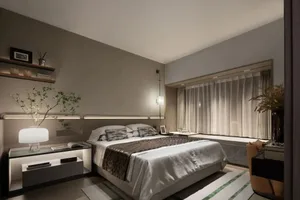 A well-lit, modern minimalist bedroom with a king-sized bed adorned with a gray and black striped duvet and pillows, accompan