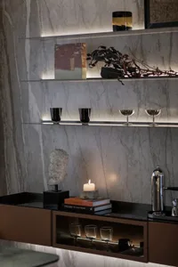 Modern living room with marble accents, glass decor, and metallic elements.