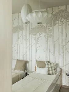 Modern minimalist bedroom with trees patterned wallpaper, linen bedding, and wooden furniture.