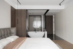 A modern bedroom featuring a bed with a grey headboard, a white and wooden floor, a marble bathtub, and wooden walls.