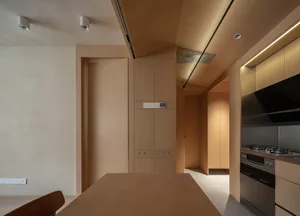 A modern kitchen featuring wooden furniture and a clean, minimalist design.