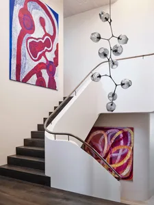Modern interior with wooden staircase and glass lighting fixture