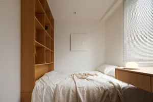 A minimalist bedroom with a bed, nightstand, and wooden shelves.