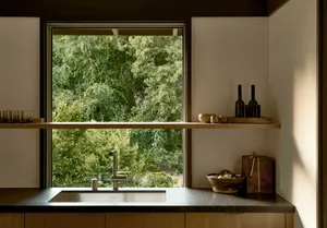 Modern minimalist kitchen with glass countertop.
