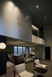 Modern residential interior designed with concrete walls and minimalist furniture.