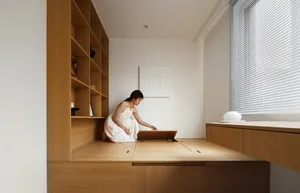 A modern office environment featuring wooden furniture and flooring.