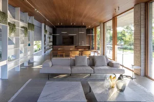 Modern living room featuring wood, glass, and marble materials and design.