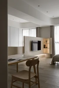 A modern living room featuring light wooden furniture, minimalistic decor, and a sleek, contemporary design.