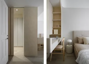 A minimalist bedroom featuring neutral tones with a wooden desk, a soft bed, and built-in shelves.