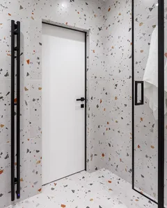 A modern bathroom with terrazzo tiles on the walls and floor