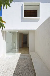 Modern residential entrance featuring concrete and glass