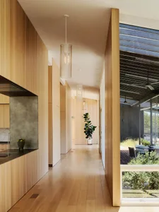 Modern entryway featuring wooden walls with pendant lights.