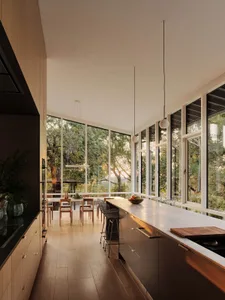 Contemporary kitchen featuring a sleek, minimalistic design with a marble countertop and floor-to-ceiling windows.