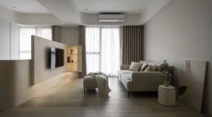 A minimalist living room featuring modern materials and a cozy, yet stylish atmosphere.