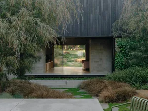 Modern residential exterior with wooden elements and landscaping