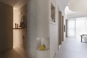 Minimalist apartment with modern ceramic walls, white wood flooring, and white curtains by day.