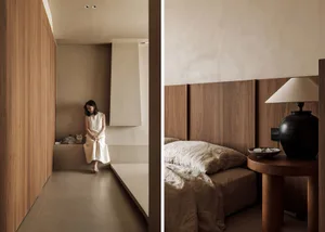 A serene minimalist bedroom with wooden walls and a cozy ambiance.
