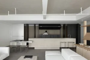 Modern, minimalist interior featuring a concrete bar and seating area.