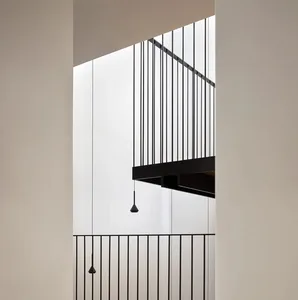 Modern, minimalist interior space with black metal railings.