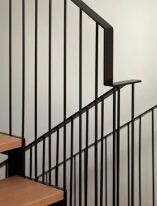 Modern interior space featuring a sleek, metal staircase with wooden steps and a metal handrail.