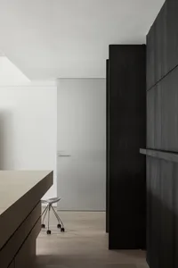 Modern kitchen with wooden cabinets and flooring.