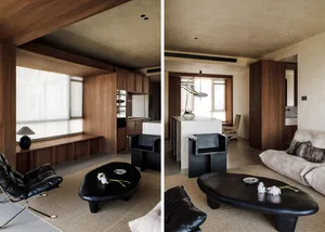 Modern living room interior with wooden furniture and exposed ceiling beams.