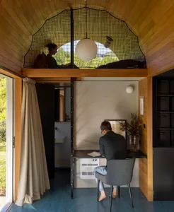 Minimalist home office with wooden elements and a desk.