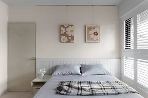 A minimalist bedroom featuring mixed materials and patterns.