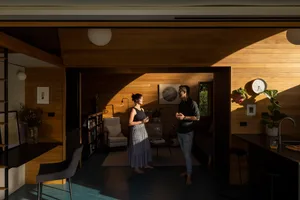A modern interior design featuring wooden walls, glass elements, and steel accents.