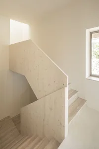 Modern staircase with wooden handrails and steps.