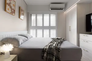 Minimalist bedroom with gray walls, bed, and furniture