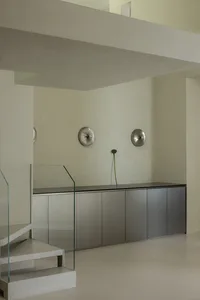 Minimalist interior space featuring sleek metal cabinets and a clean, modern design.