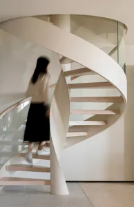 A modern floating staircase constructed from wood, glass, and metal materials.