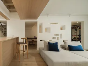 Modern residential living room with mixed materials and furniture.