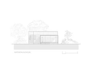 A modern sustainable house with metal cladding and glass features.