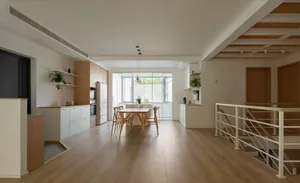 Modern living room with an open-plan design and wooden flooring and furniture.