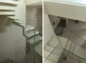 Modern glass stairs with white steps and metal handrail