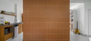 A minimalist kitchen with a terracotta tile wall