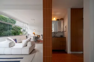 Modern minimalist residential space featuring exposed concrete walls and floor-to-ceiling windows.