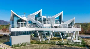 A modern building with a glass exterior and a white facade.