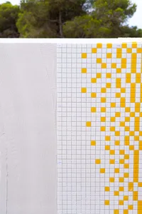 Modern minimalist architecture featuring white and yellow tiles on a wall