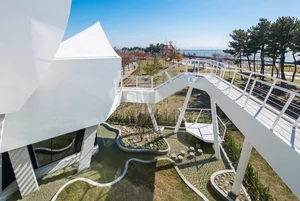 A modern park featuring concrete pathways and seating areas.