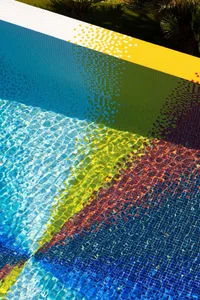 A vibrant, tiled poolside area with colorful gradients.