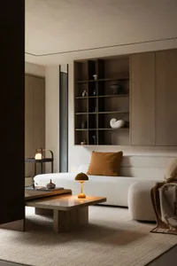A modern living room featuring white furniture, wooden shelves, and marble coffee table.